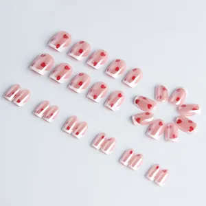 Short square glossy press-on nails with pink base, white French tips and red hearts