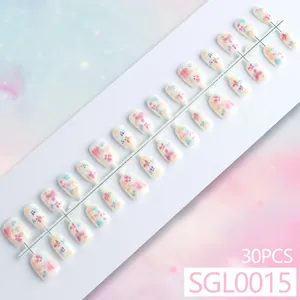 Short coffin press-on nails with sweet pastel floral patterns and 30-piece set display