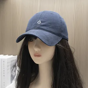 Detailed view of the navy blue cotton canvas baseball cap with white embroidered O logo