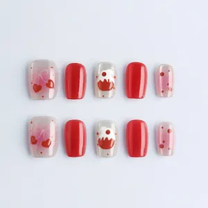 Cat eye press-on nails with red heart and bow designs in short trapezoid shape