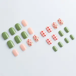 Short square press-on nails set with pink floral and green plaid patterns