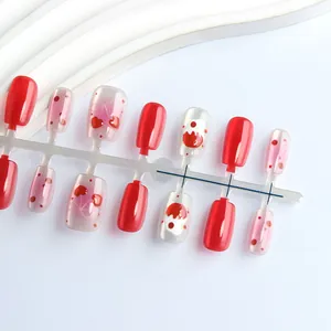 Detail view of red heart bow cat-eye press-on nails set on a clean display stand