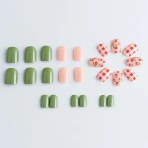 Short square press-on nails in sage green and pink with floral and plaid patterns