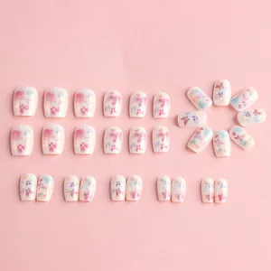 Floral watercolor press-on nails with butterflies and metallic accents in short coffin shape