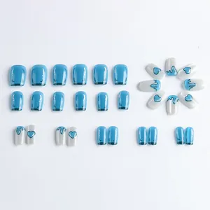 Short square press-on nails with blue cat-eye effect and minimalist heart patterns