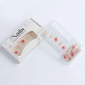 Detail of sweet strawberry press on nails packaging with red polka dots and cute patterns