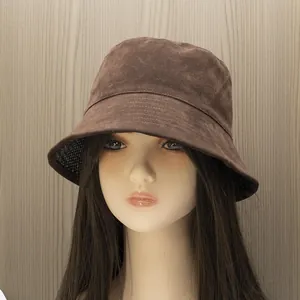 Detail of dark brown faux suede bucket hat featuring breathable black mesh lining