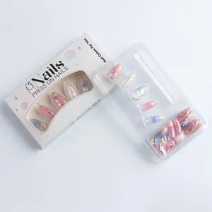 Détail des faux ongles amande avec relief floral et finition œil de chat aurora