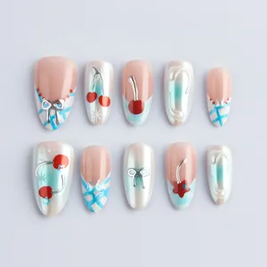 Glossy almond press-on nails with 3D cherry accents and gradient blue ribbon designs