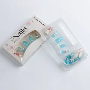 Detail of almond-shaped blue press-on nails with 3D starfish and shell embossed texture