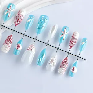 Detail of almond press-on nails with 3D ocean starfish, shell relief and pearl accents