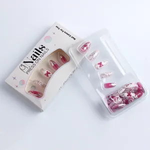 Detail of pink cat-eye press-on nails with 3D butterfly relief in gift packaging box