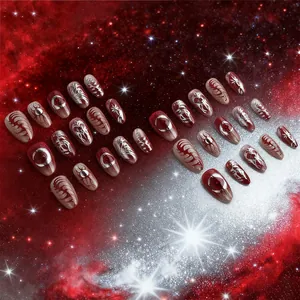 Starry sky press-on nails with dark red gradient and metallic gold celestial art