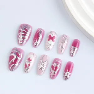 Pink cat eye almond press-on nails with 3D silver butterflies and Y2K heart designs