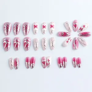 Pink almond press-on nails with 3D silver relief butterflies and heart patterns