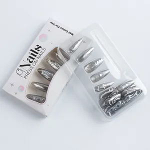 Detailed view of silver cat-eye press-on nails with heart patterns in a white window box