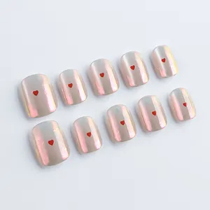 Short round pink aurora nails with tiny red hearts and pearlescent gradient finish