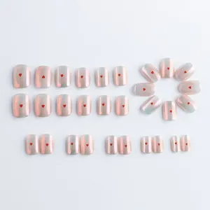 Pink gradient press-on nails with red heart patterns and pearlescent aurora finish