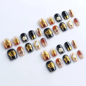 Short cat-eye press-on nails with 3D gold embossed flowers and brown gradient design