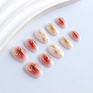 Short oval gradient pink press-on nails with 3D gold embossed heart and bow designs