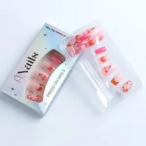 Close-up of pink floral press-on nails with cherry designs in a stylish gift box