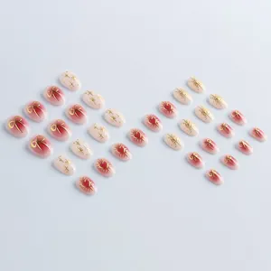 Short oval press-on nails with pink gradient, golden 3D bows and heart patterns