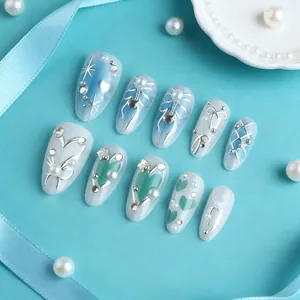 Elegant 3D blue gradient press-on nails with almond shape, pearls, and silver bows