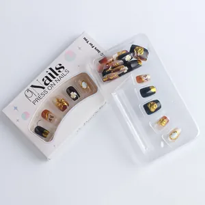 Detail of press-on nails featuring cat eye effect and gold embossed floral patterns