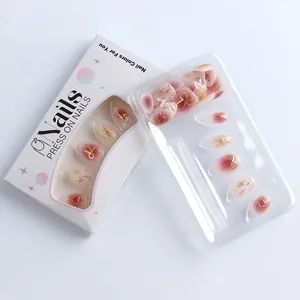 Detail view of pink gradient press-on nails with golden heart and star 3D embossed designs