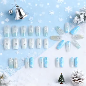 Blue and white cat-eye press-on nails with silver snowflakes for a winter holiday look