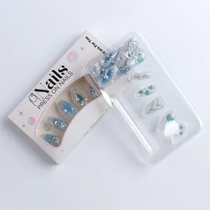 Detailed set of 3D blue gradient press-on nails with silver hearts and rhinestones in package