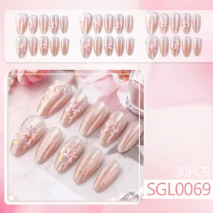 Short almond press-on nails with 3D floral relief, pink gradient, and gold foil accents