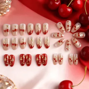 Short oval cherry cat-eye press-on nails with golden accents and red velvet background