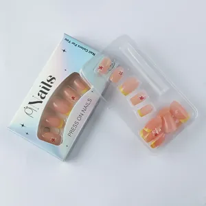 Detail of yellow French floral press-on nails set in elegant light blue packaging box