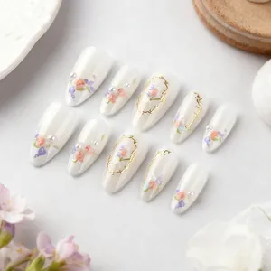 Almond press-on nails with floral rose painting, pearls, and gold foil accents