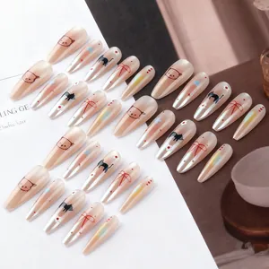 Long almond cat eye press-on nails with cute floral patterns and pink pearl finish