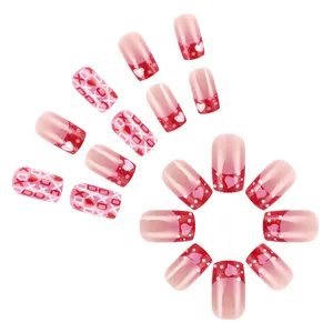 Glossy red heart press-on nails with XOXO prints and glitter french tips for Valentine's
