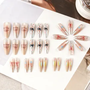 Close-up of almond cat-eye press-on nails with cartoon cat and floral patterns