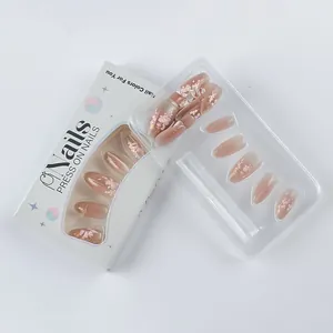 Detailed close-up of pink press-on nails with 3D floral relief in white packaging box