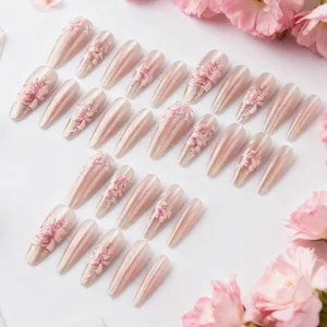 Long almond cat-eye press-on nails with 3D embossed pink flowers and pearl finish