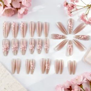 Macro detail of long almond cat eye press-on nails with 3D floral petals and pink gradient
