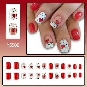 Short square press-on nails with red heart patterns and black dots design