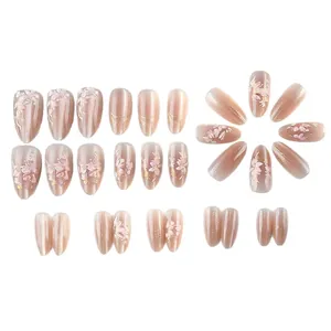Short almond cat eye press-on nails with 3D floral relief and gold glitter details