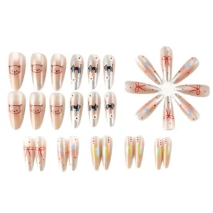 Long almond press-on nails with pearl finish featuring cute cartoon cats and floral patterns