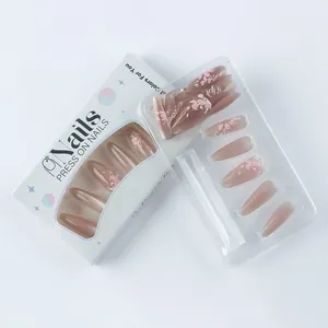 Close-up of pink cat eye press-on nails with 3D floral art in white window box