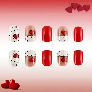 Short square press-on nails with red hearts and black polka dots for Valentine's Day