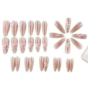 Long almond cat-eye press-on nails with 3D floral designs and pink gradient finish