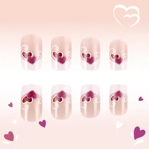 Close-up of glossy press-on nails featuring purple and red glitter hearts and white line art