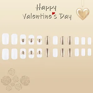 Medium heart press-on nails set with champagne gold glitter and white glossy finish