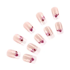 Detail of glossy purple French fake nails with glitter hearts and white line patterns